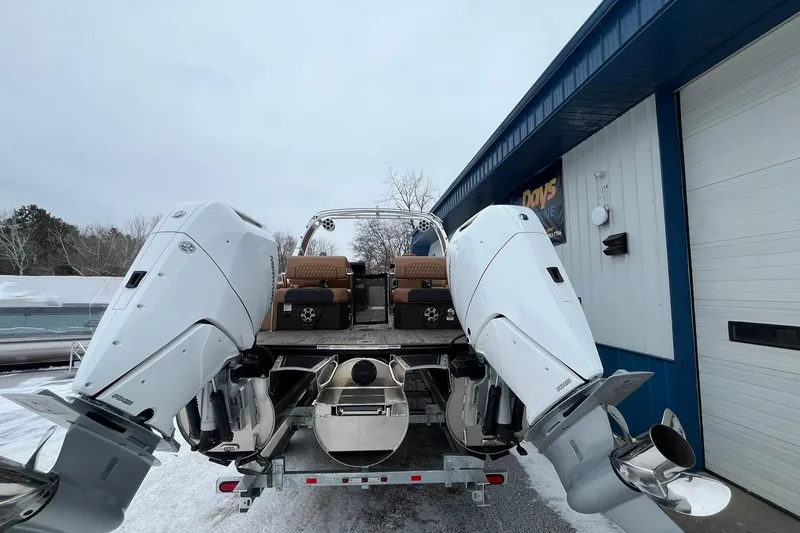 Slide: The Image of 2026 Avalon Excalibur LTD Quad Lounge boat with dual outboard motors in snowy setting. - 3