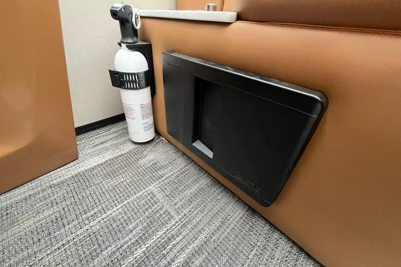 Slide: The Image of Fire extinguisher and storage compartment in 2026 Avalon Excalibur LTD Quad Lounge interior. - 33