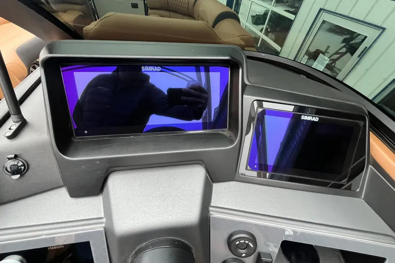 Slide: The Image of 2026 Avalon Excalibur LTD Quad Lounge dashboard with dual Simrad displays. - 37