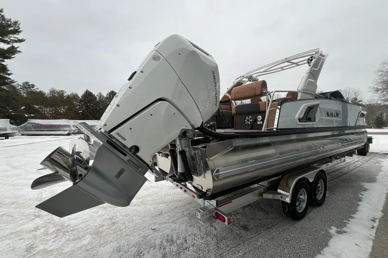 Slide: The Image of 2026 Avalon Excalibur LTD Quad Lounge pontoon boat with Mercury outboard engine on trailer. - 4