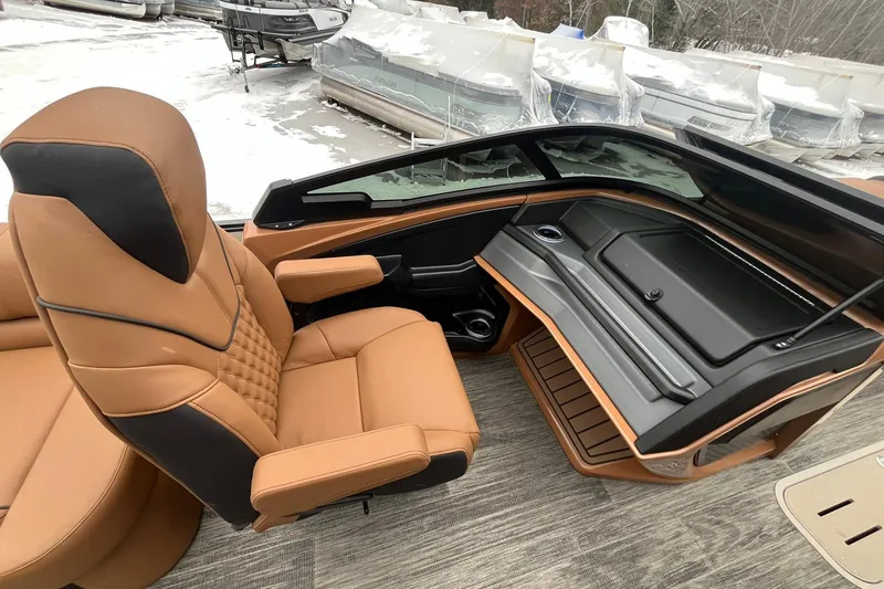 Slide: The Image of Luxurious interior of 2026 Avalon Excalibur LTD Quad Lounge boat with tan seating and sleek dashboard. - 40