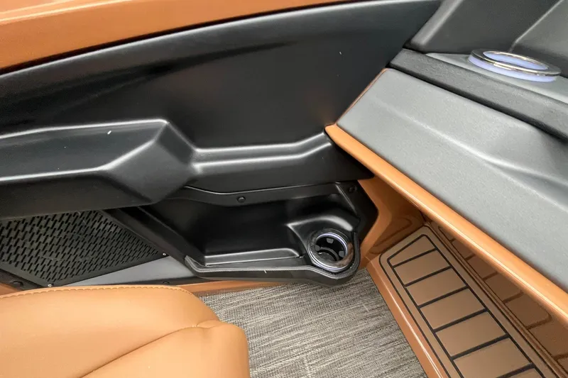 Slide: The Image of Interior of 2026 Avalon Excalibur LTD Quad Lounge with cup holder and brown leather seat. - 42