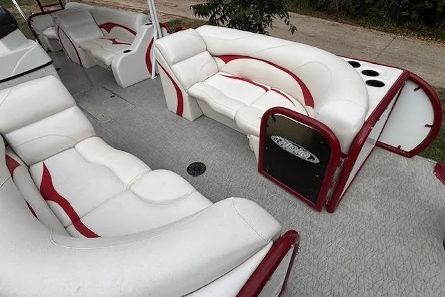 Slide: The Image of 2022 Aloha Pontoon Tropical 260 interior with white and red seating. - 10