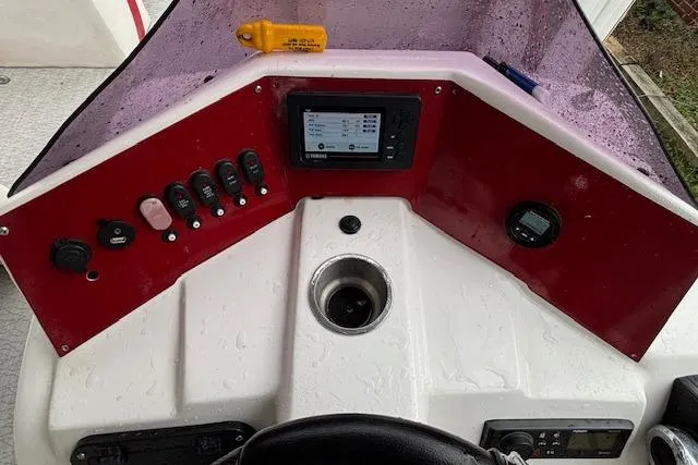 Slide: The Image of Control panel of 2022 Aloha Pontoon Tropical 260 with red dashboard and digital display. - 15