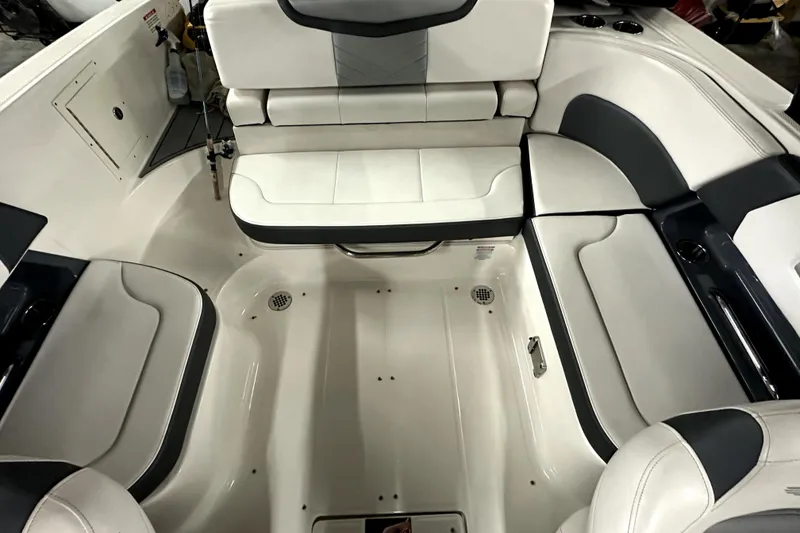 Slide: The Image of 2021 Chaparral 26 Surf boat interior with white and gray seating arrangement. - 11