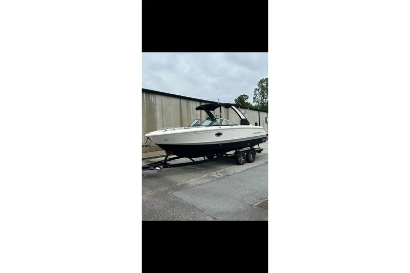 Slide: The Image of 2021 Chaparral 26 Surf boat on trailer, parked outdoors. - 16