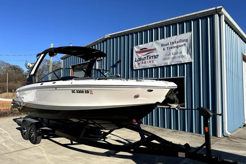 Slide: The Image of 2021 Chaparral 26 Surf boat on trailer outside LakeTime Marine building. - 3