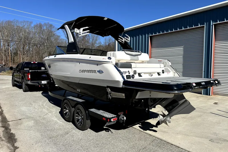 Slide: The Image of 2021 Chaparral 26 Surf boat on trailer, parked outside a storage facility. - 5