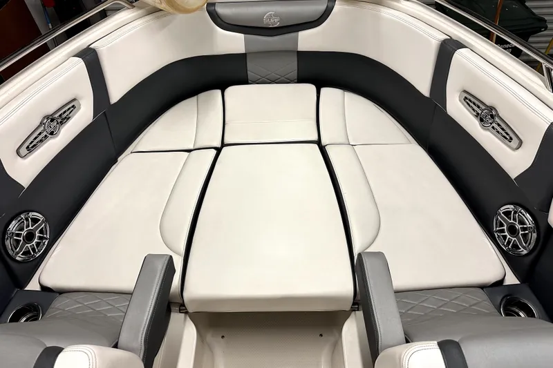 Slide: The Image of Luxurious interior of 2021 Chaparral 26 Surf boat with plush seating and speakers. - 9