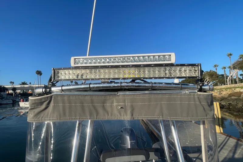 Slide: The Image of 2016 Zodiac Pro Classic 650 boat with LED light bars, docked under clear blue sky. - 15
