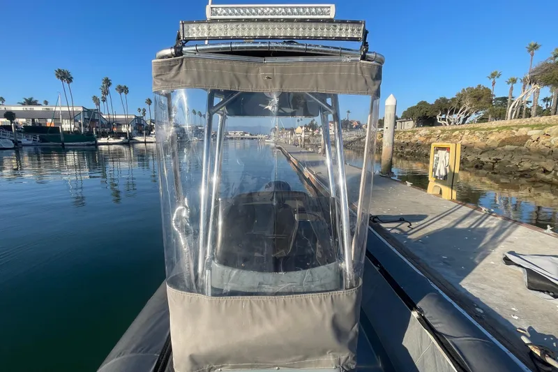 Slide: The Image of 2016 Zodiac Pro Classic 650 boat docked in a sunny marina setting. - 16