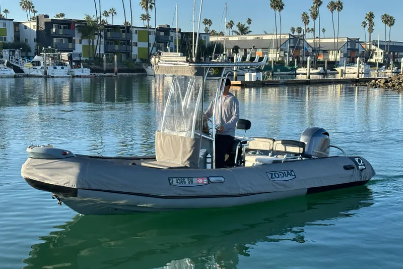 Slide: The Image of 2016 Zodiac Pro Classic 650 boat on calm water near a marina. - 4