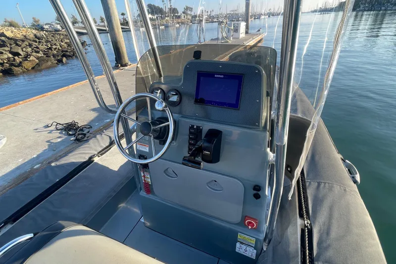 Slide: The Image of 2016 Zodiac Pro Classic 650 boat dashboard with steering wheel and navigation system. - 8