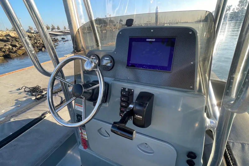 Slide: The Image of Control panel of a 2016 Zodiac Pro Classic 650 boat with steering wheel and navigation display. - 9