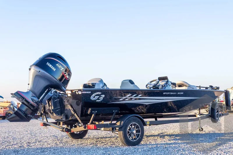 Slide: The Image of 2026 G3 Sportsman 1810 SE boat with Yamaha engine on trailer, parked on gravel. - 13