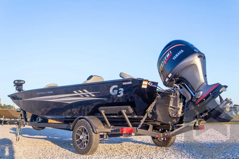 Slide: The Image of 2026 G3 Sportsman 1810 SE boat with Yamaha engine on trailer, parked outdoors. - 14