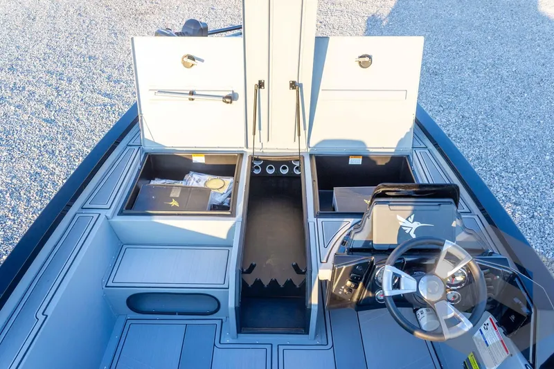 Slide: The Image of 2026 G3 Sportsman 1810 SE boat interior with open storage compartments and steering console. - 17