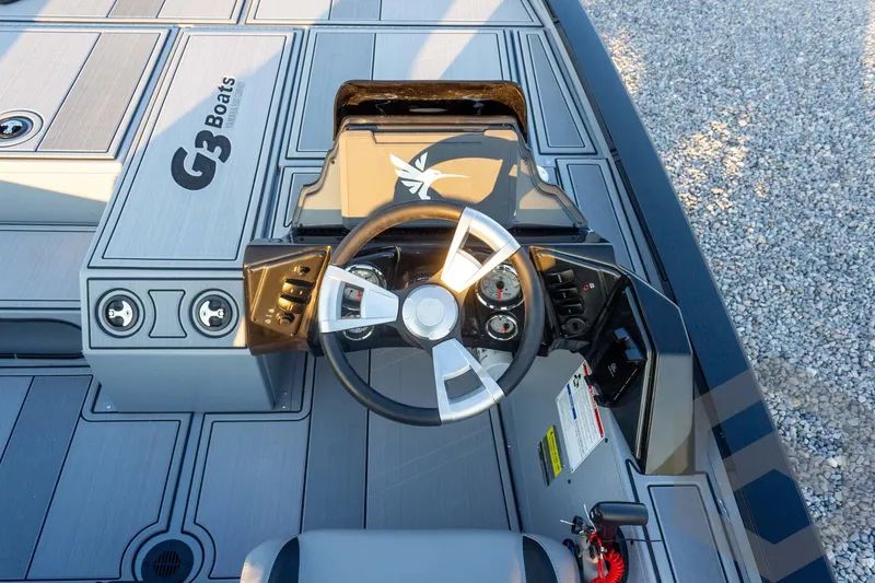 Slide: The Image of 2026 G3 Sportsman 1810 SE boat dashboard with steering wheel and controls. - 27