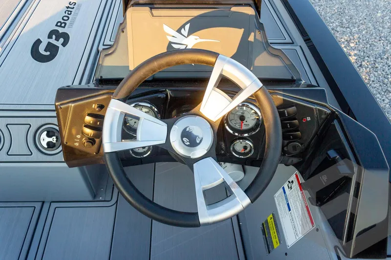 Slide: The Image of Steering wheel of 2026 G3 Sportsman 1810 SE boat with dashboard controls. - 28