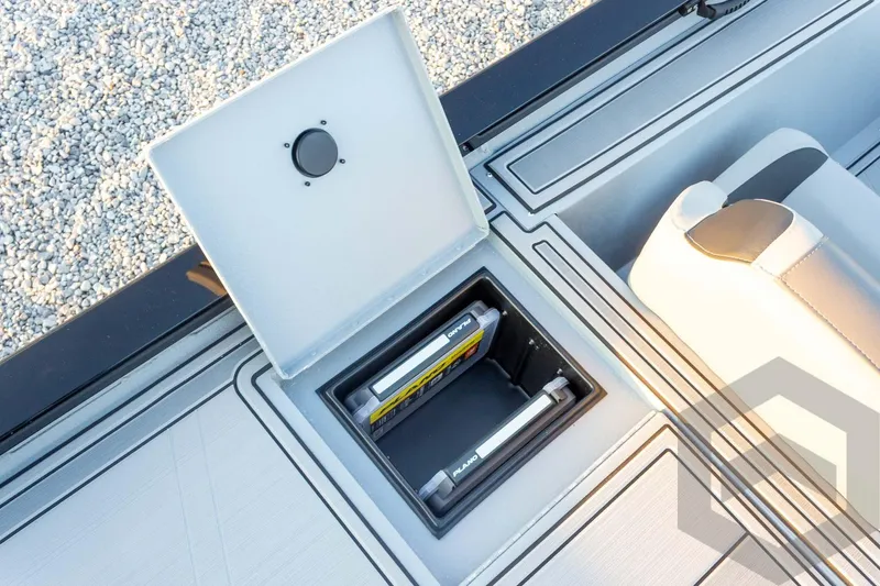 Slide: The Image of Open storage compartment on 2026 G3 Sportsman 1810 SE boat, featuring organized interior. - 35