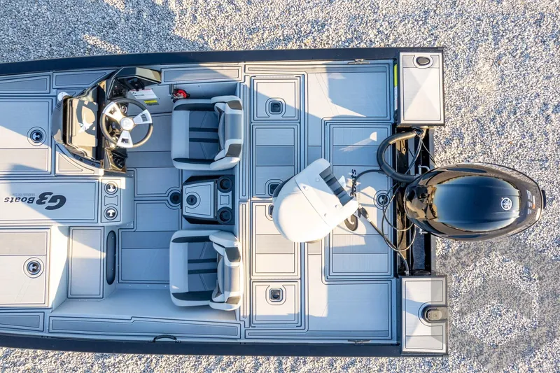 Slide: The Image of 2026 G3 Sportsman 1810 SE boat, top view, showcasing seating and motor on gravel surface. - 42