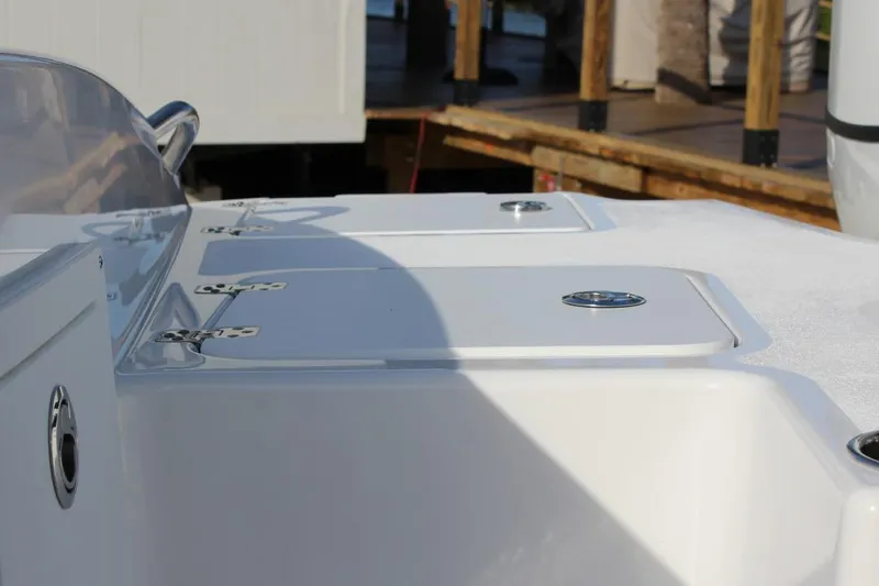Slide: The Image of 2025 NauticStar 251 Hybrid boat deck with storage compartments and sleek design. - 11