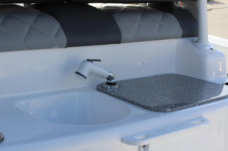 Slide: The Image of 2025 NauticStar 251 Hybrid boat interior with sink and faucet detail. - 12