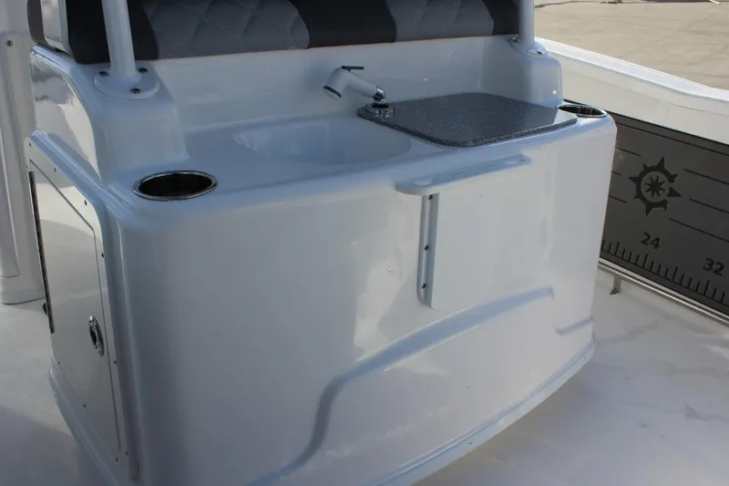 Slide: The Image of 2025 NauticStar 251 Hybrid boat interior with sink and storage area. - 13