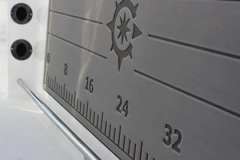 Slide: The Image of Ruler detail on 2025 NauticStar 251 Hybrid boat, featuring compass design. - 15