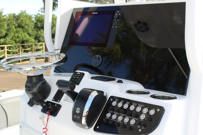 Slide: The Image of 2025 NauticStar 251 Hybrid boat dashboard with steering wheel and control panel. - 17