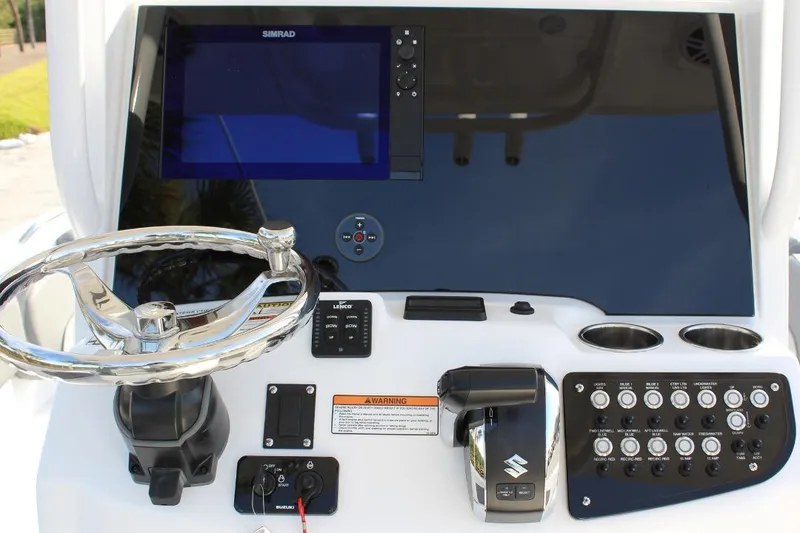 Slide: The Image of 2025 NauticStar 251 Hybrid boat dashboard with steering wheel and control panel. - 21