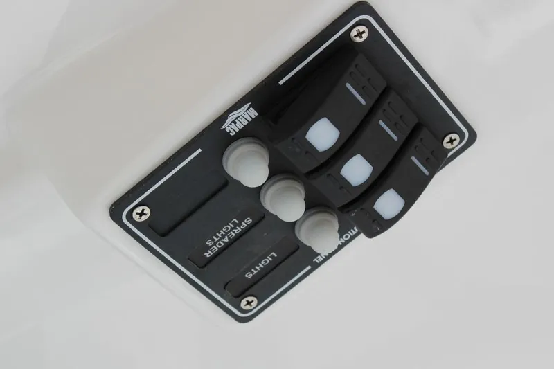 Slide: The Image of Control panel of 2025 NauticStar 251 Hybrid boat with labeled switches. - 22
