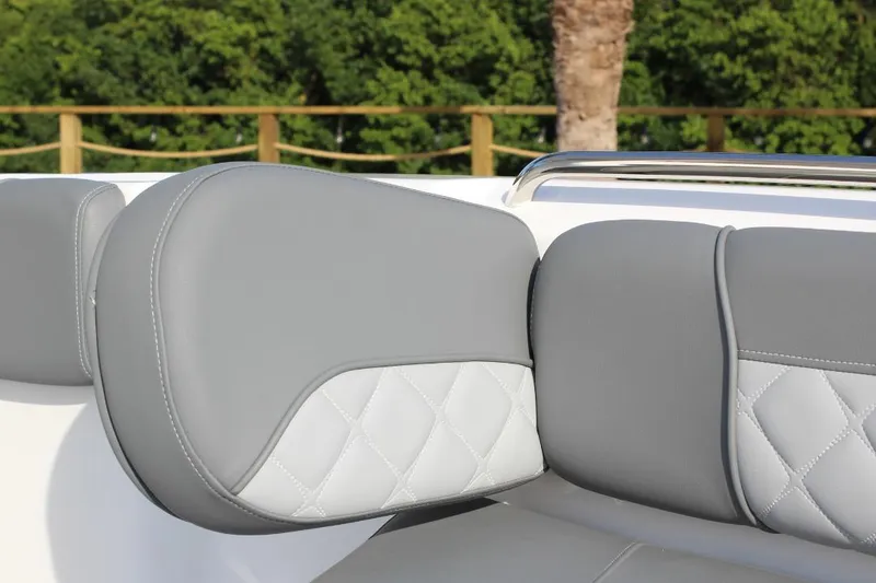 Slide: The Image of 2025 NauticStar 251 Hybrid boat seat with gray and white quilted upholstery. - 26