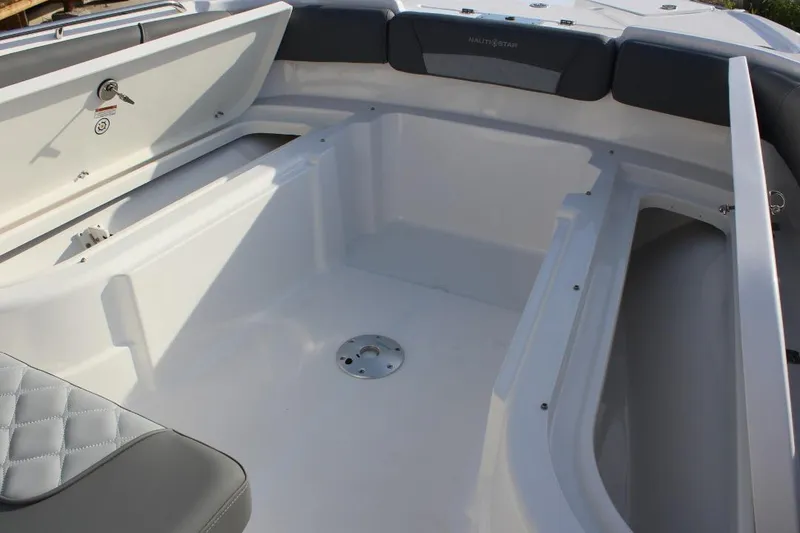 Slide: The Image of Interior view of 2025 NauticStar 251 Hybrid boat, featuring spacious seating and storage compartments. - 30