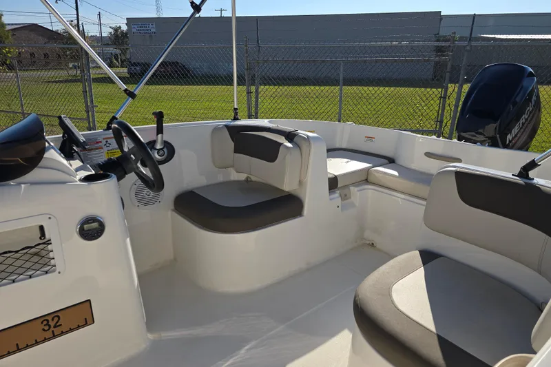Slide: The Image of 2019 Bayliner Element E16 boat interior with seating and steering wheel. - 12