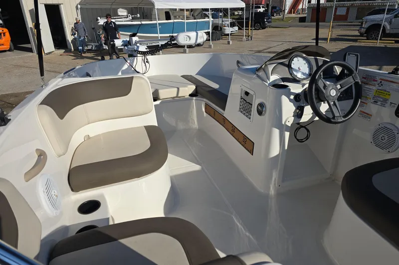 Slide: The Image of 2019 Bayliner Element E16 boat interior with seating and steering wheel. - 13