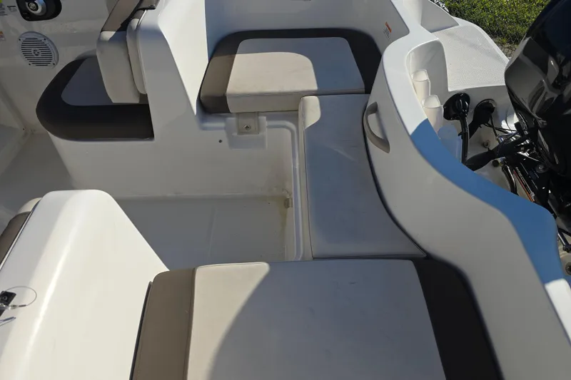 Slide: The Image of 2019 Bayliner Element E16 boat interior with cushioned seating and storage compartments. - 14