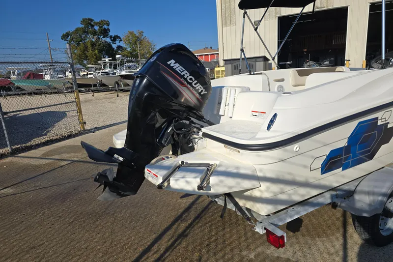 Slide: The Image of 2019 Bayliner Element E16 boat with Mercury outboard motor, parked outdoors. - 7