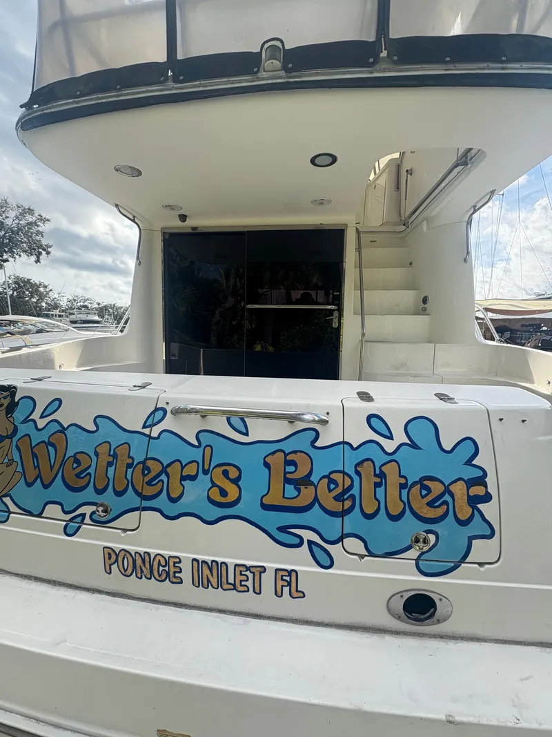 Slide: The Image of Rear view of 2001 Sea Ray Five Forty yacht with "Wetter's Better" lettering. - 14