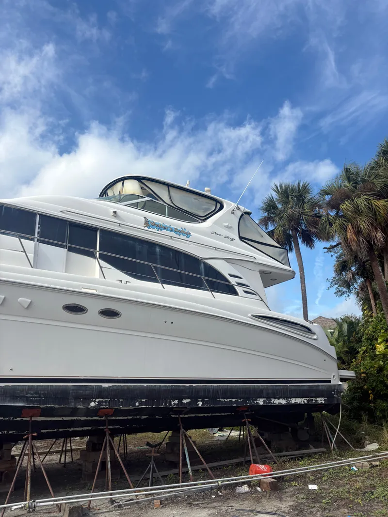 Slide: The Image of 2001 Sea Ray Five Forty yacht on stands under blue sky. - 3