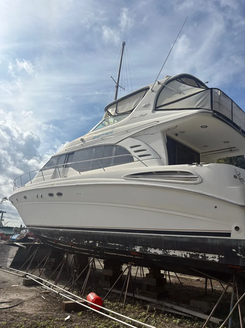 Slide: The Image of 2001 Sea Ray Five Forty yacht in dry dock under blue sky. - 5