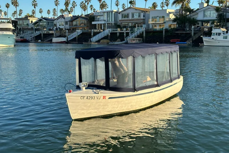 Slide: The Image of 2017 ElectraCraft 18 LS boat on calm water near waterfront homes. - 4