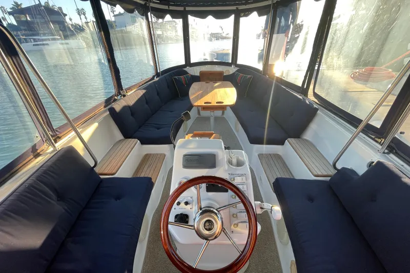 Slide: The Image of Interior of a 2017 ElectraCraft 18 LS boat with spacious seating and steering wheel. - 7