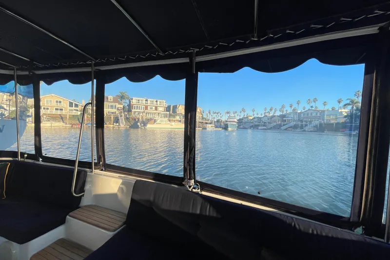 Slide: The Image of Interior view from 2017 ElectraCraft 18 LS boat, overlooking waterfront homes and palm trees. - 9