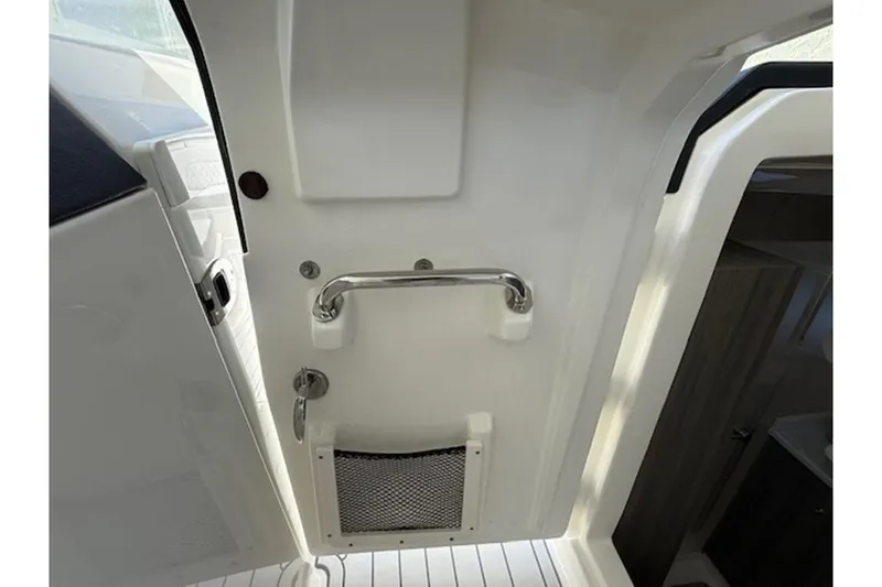 Slide: The Image of Interior view of 2021 World Cat 400 DC-X boat, featuring a sleek white design and metal handle. - 10