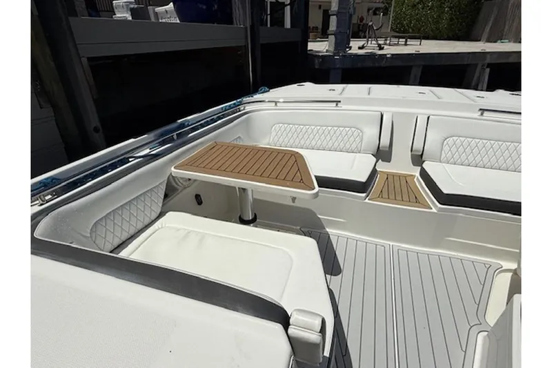 Slide: The Image of Luxurious seating area on 2021 World Cat 400 DC-X boat with elegant wood table. - 13