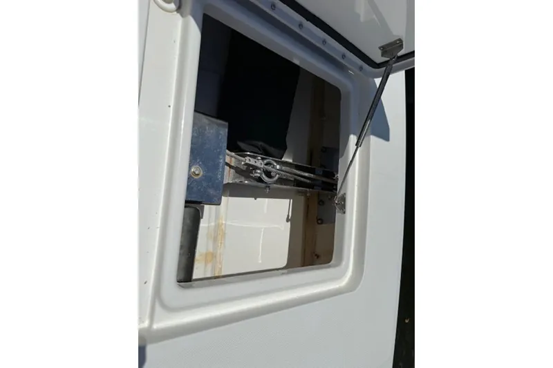 Slide: The Image of Open hatch on 2021 World Cat 400 DC-X boat, showing interior mechanism. - 16