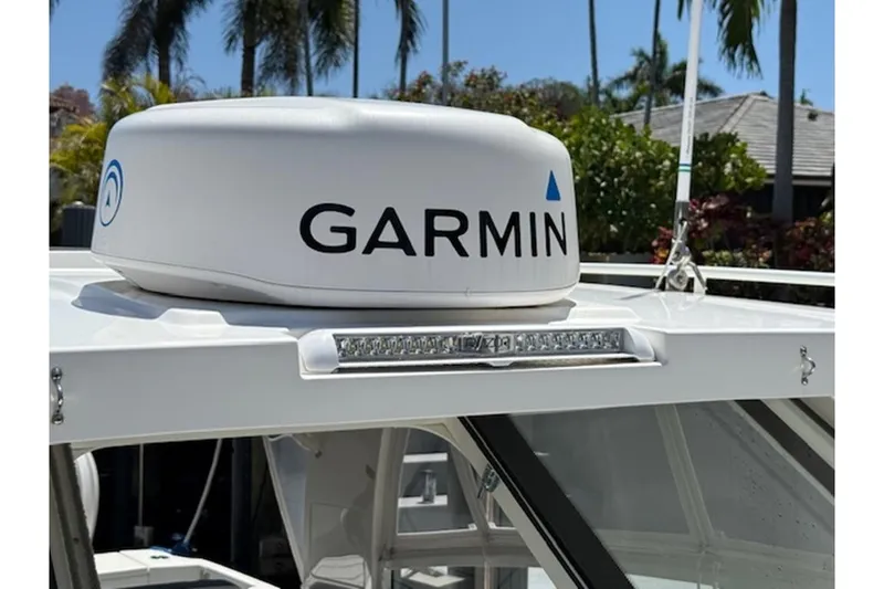 Slide: The Image of Garmin radar on 2021 World Cat 400 DC-X boat, surrounded by palm trees. - 19