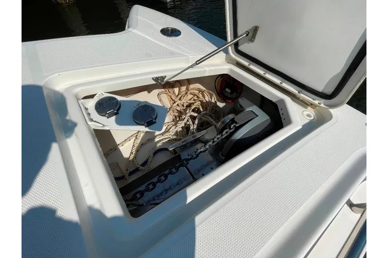 Slide: The Image of Open storage compartment on 2021 World Cat 400 DC-X boat, showing ropes and anchor chain. - 29