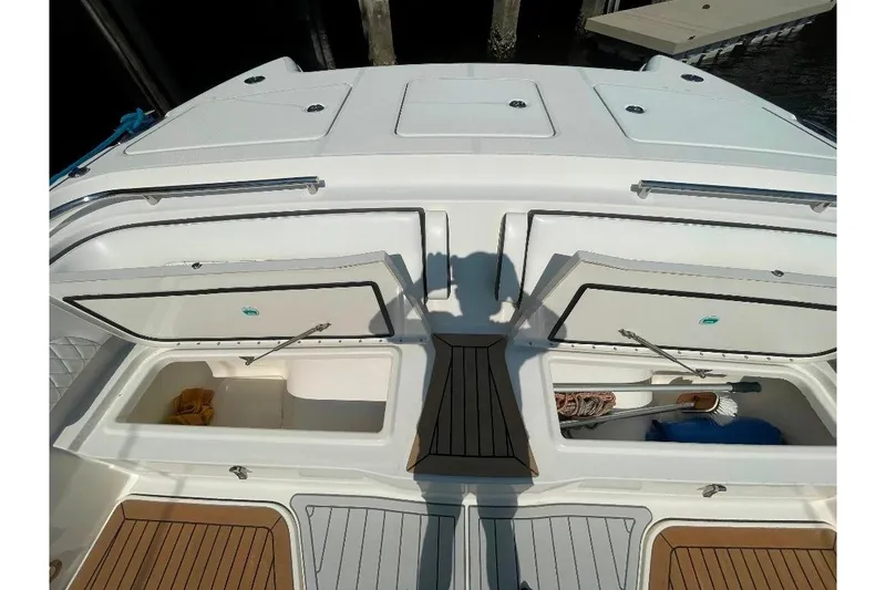 Slide: The Image of 2021 World Cat 400 DC-X boat storage compartments with open hatches and visible equipment. - 33